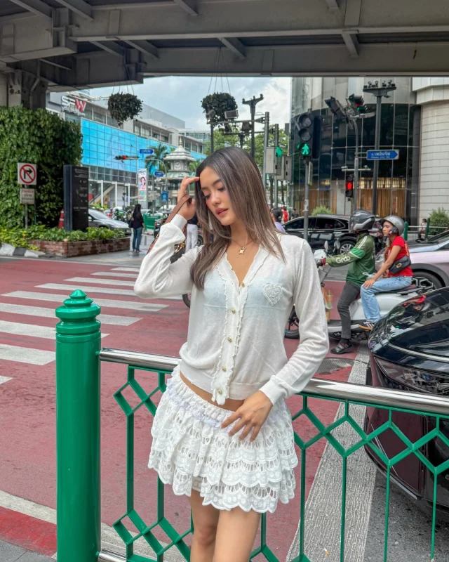 Khun @yoghurt_nattasha wearing the Morning Glow Cardigan and Cloud Ruffle Mini Skirt — a soft, feminine look made for a city stroll.  #KlosetPF26
#KlosetICantStop